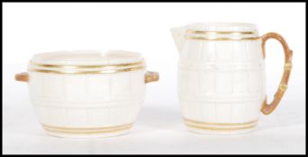 A 19th century Grainger & Co Royal China Co Worcester barrel shaped creamer and sugar bowl each with