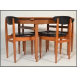A 20th Century retro 1960's teak wood extending dining table of oval form raised on tapering legs