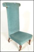 A 19th Century Victorian prie dieu / prayer chair finished in blue velour upholstery having turned