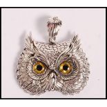 A stamped 925 silver pendant / brooch in the form of an owl set with yellow and black gallas eyes.