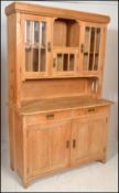 An antique style Scandinavian Art Nouveau manner pine dresser cabinet. The base with short drawers