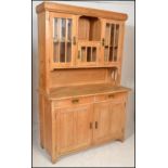 An antique style Scandinavian Art Nouveau manner pine dresser cabinet. The base with short drawers