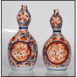 A pair of 19th Century Imari red, blue and white Japanese double gourd vases, having floral
