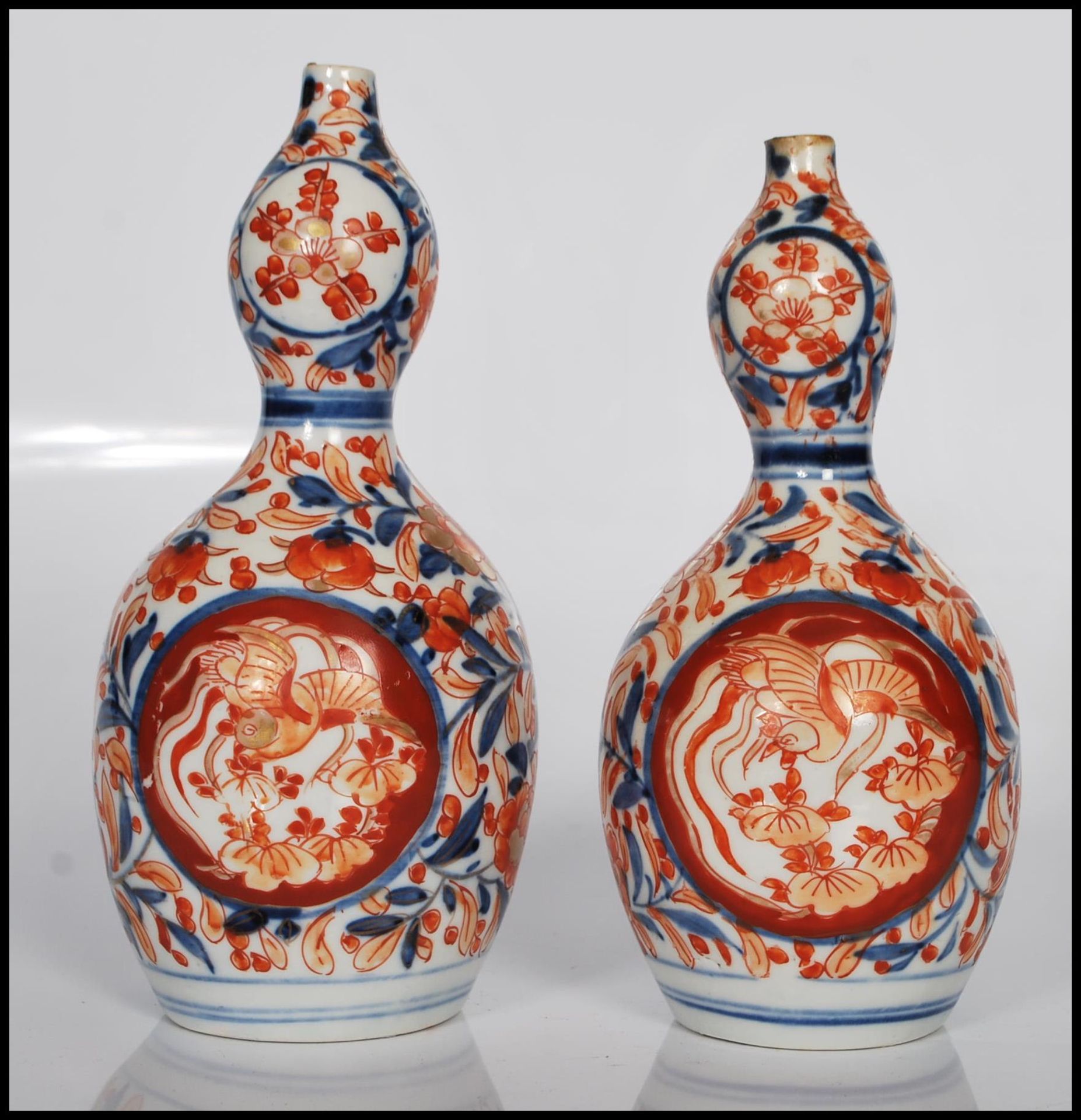 A pair of 19th Century Imari red, blue and white Japanese double gourd vases, having floral