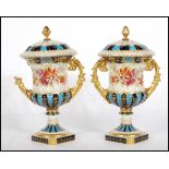 A pair of 19th Century Continental twin handled lidded mantel urns, gilt scroll handles on square