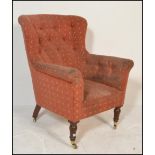 A Victorian 19th century Chesterfield / club armchair being raised on mahogany turned legs with
