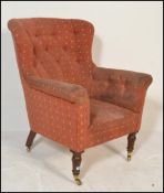 A Victorian 19th century Chesterfield / club armchair being raised on mahogany turned legs with