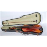 A 20th Century Violin musical instrument having a one piece maple back with spruce front. Ebonised