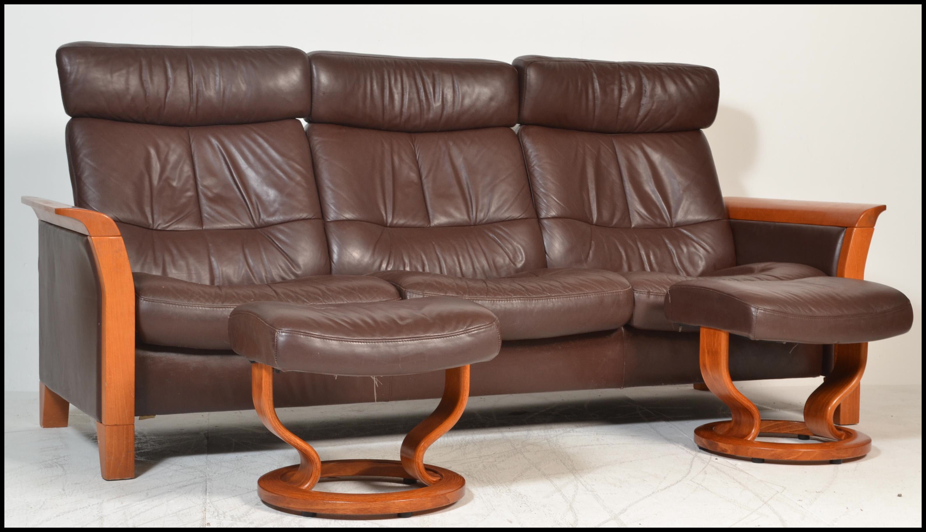 An Ekornes Stressless three seater brown leather Reclining Sofa of Scandinavian design, having