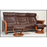 An Ekornes Stressless three seater brown leather Reclining Sofa of Scandinavian design, having