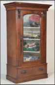 A Victorian 19th century wardrobe / armoire. Raised on a plinth base with single drawers. Above a