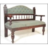 A 20th Century Victorian style /  gothic revival oak framed hall settle, button back embroidered