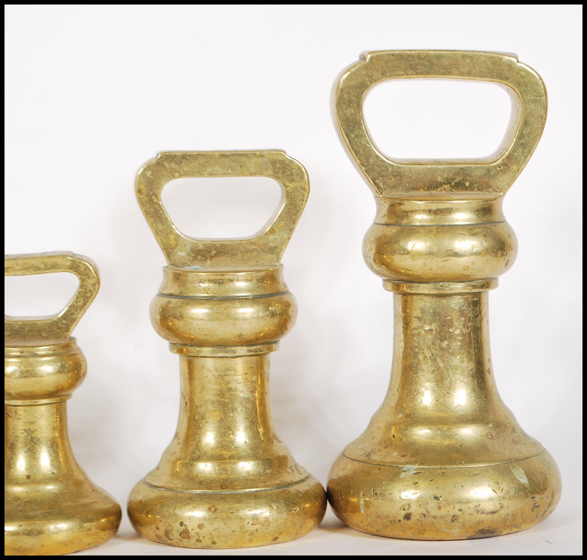 A selection of 20th century graduating brass bell weights having carrying handles atop, with the - Image 4 of 7