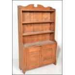 A Victorian 19th century country pine open window bookcase cabinet having shaped uprights with