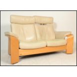 A stunning Ekornes Stressless two seater plus system reclining leather sofa, upholstered in white