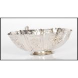 A 19th Century continental silver bonbon dish of oval form with twin handles. The body having floral