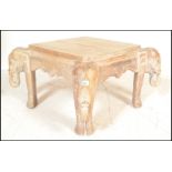 An antique style hardwood African occasional / coffee table. Each leg being carved in the form of an