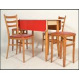 A retro mid century red formica and beech wood drop leaf kitchen dining table having a matching pair