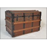 A Victorian 19th century wooden and canvas bound large dome top steamer trunk. Brown canvas with