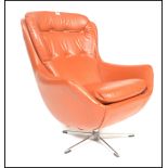 An original 1960's retro vintage red button back swivel egg type chair / armchair being raised on