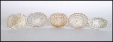 A group of five 19th Century ceramic miniature jelly moulds three having fruit designs to the tops