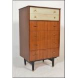 A mid 20th Century retro G-Plan style chest of drawers raised on ebony tapering square legs with