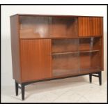 A vintage mid 20th Century teak wood sideboard credenza by Nathan having a configuration of glazed