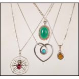 A collection of four silver chain pendant necklaces to include a spider sat upon a wed with