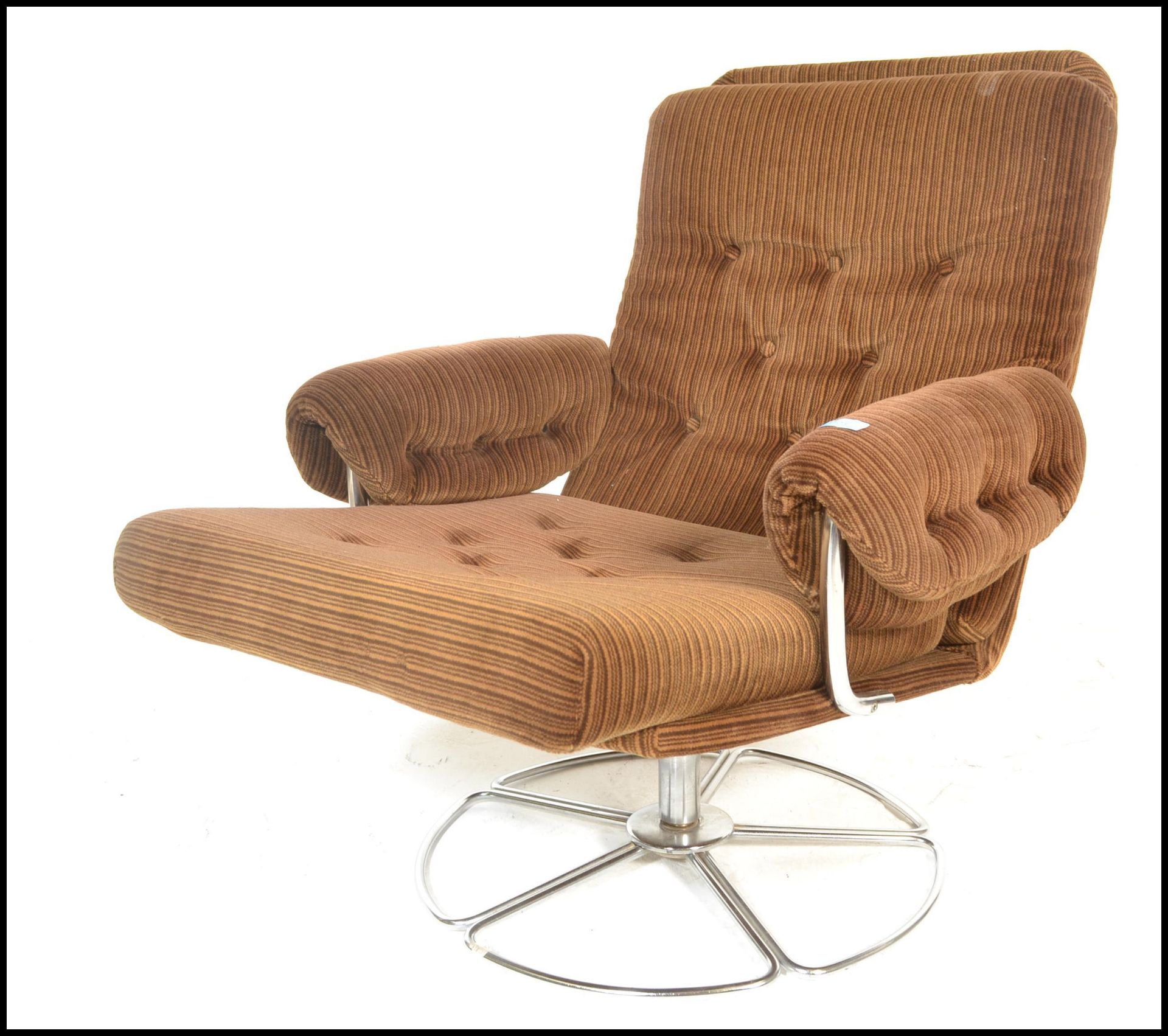 A mid century retro Danish influenced swivel easy armchair being upholstered in the original