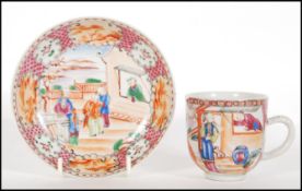 A 19th Century Chinese cup and saucer having hand painted oriental scene with floral and pattern