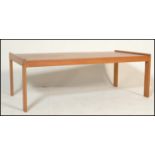 A retro mid 20th Century ash coffee table of simple rectangular form raised on four straight legs.