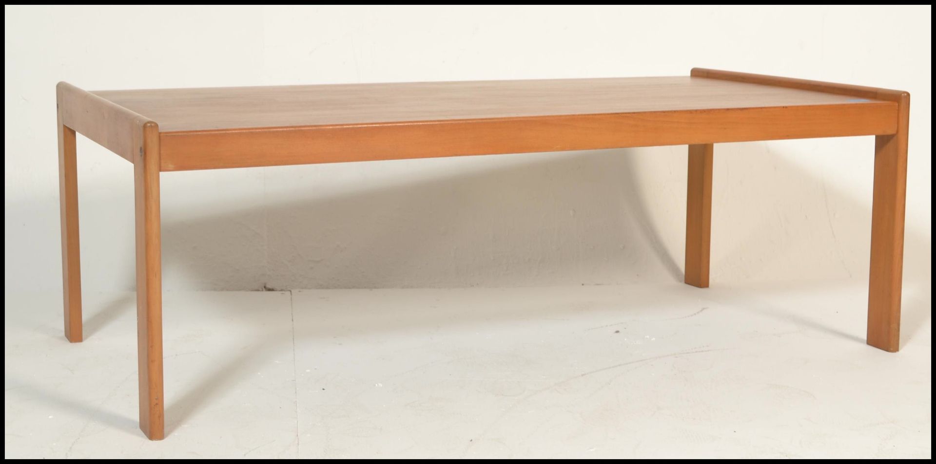 A retro mid 20th Century ash coffee table of simple rectangular form raised on four straight legs.