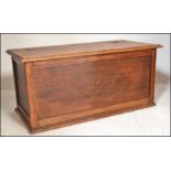 A 20th Century oak panelled coffer / blanket box chest, hinged panelled top raised on a plinth
