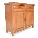 An early 20th Century Edwardian oak sideboard having twin cupboard doors with two drawers above,