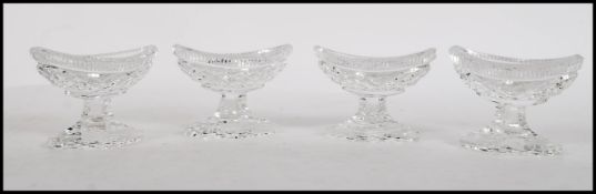 A set of four 19th Century Victorian hobnail cut glass table salts raised on stepped diamond