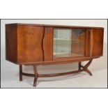 A retro 20th Century teak wood sideboard / credenza - cocktail cabinet dresser having revolving