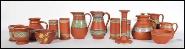 A collection of late 19th Century Terracotta Pratt ware consisting of  prattware jugs, cylindrical