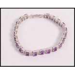 A stamped 925 silver bracelet set with oval cut amethysts and round cut CZ's. Weight 22.1g. Measures