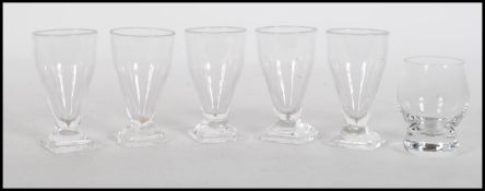 A set of five 19th Century hand blown liqueur / toddy glasses set on a square base raised on a
