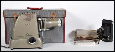 A vintage Aldis slide projector with original instructions, contained within original gray and red