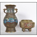 A 20th Century Chinese brass oriental vase of bulbous form having twin handle atop with enamel