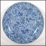 A 18th Century Chinese Kangxi Qing dynasty large dish / charger plate, decorated with blue and white