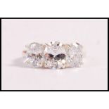A stamped 925 silver dress ring set with three oval cut CZ's. Total weight 5.1g. Size P.