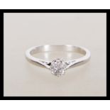 A stamped 18ct white gold solitaire ring set with a brilliant cut diamond. Weight 2.5g. Size J.