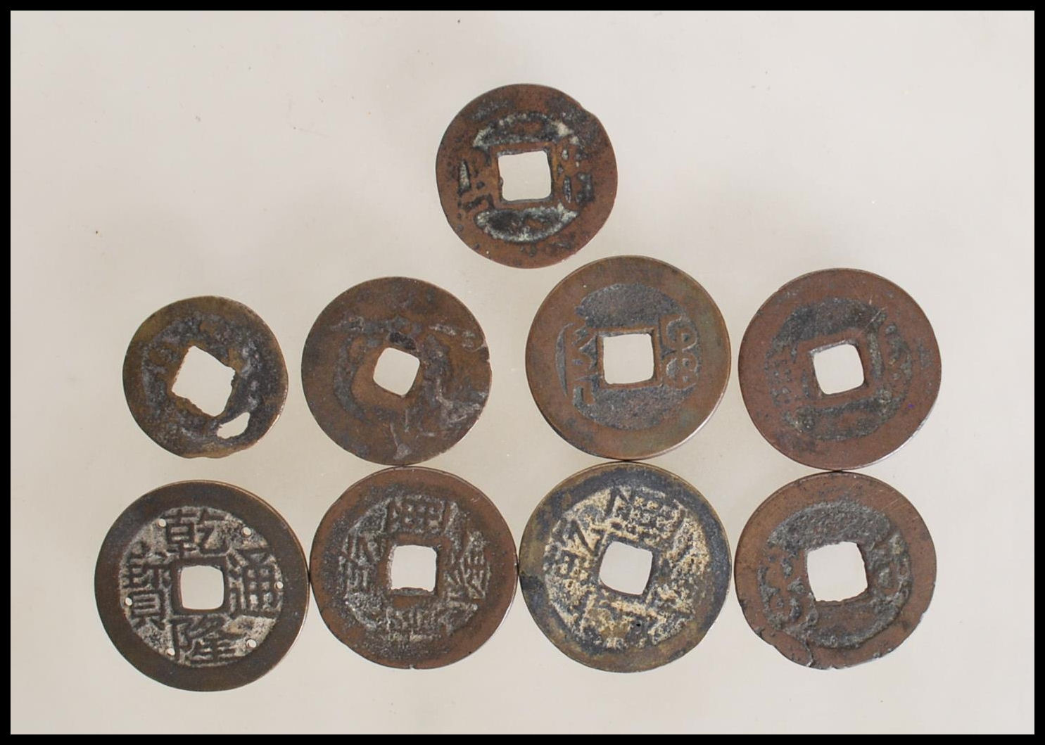 A group of nine Chinese tang dynasty coins having square pierced centres. Nine in total.