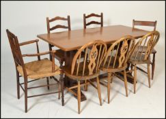 An early 20th century golden oak refectory dining table. Raised on twin square column end supports