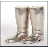 A pair of 20th Century silver plated drinks measures in the form of riding boots having raised