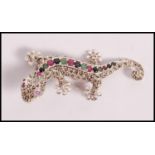 A stamped 925 silver brooch in the form of a lizard set with cz's, rubies, sapphires and emeralds.