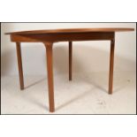 A retro 20th Century teak wood Nathan dining table. The extendable dining table of circular form