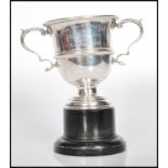 WITHDRAWN-  A hallmarked silver early 20th century twin handled trophy cup raised on stepped